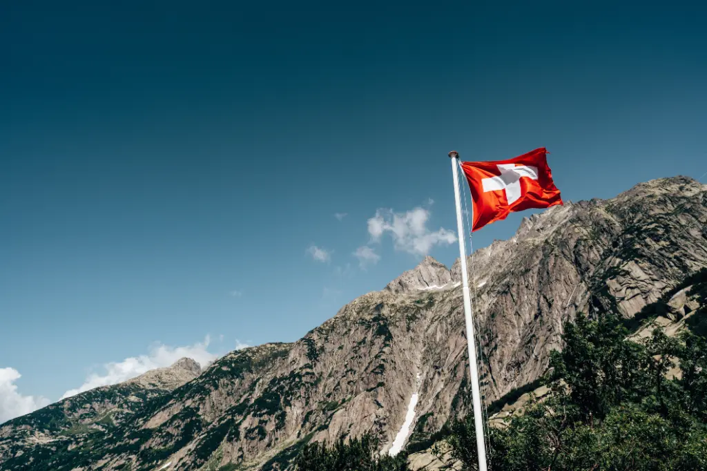 Swiss flag with mountains in background