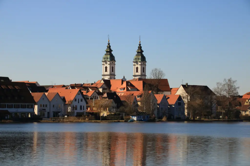 View of the town of Bad Waldsee. The spires of the collegiate church reflected in the town lake